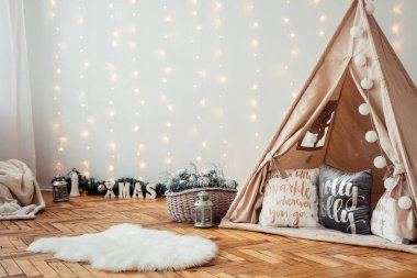 Children's Christmas Location. Beige Wigwam Decorated for New Year. Photo Zone for children in Rustic Style.