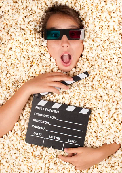 Young girl buried in popcorn — Stock Photo, Image