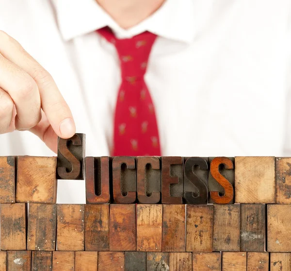 Business man building success word — стоковое фото