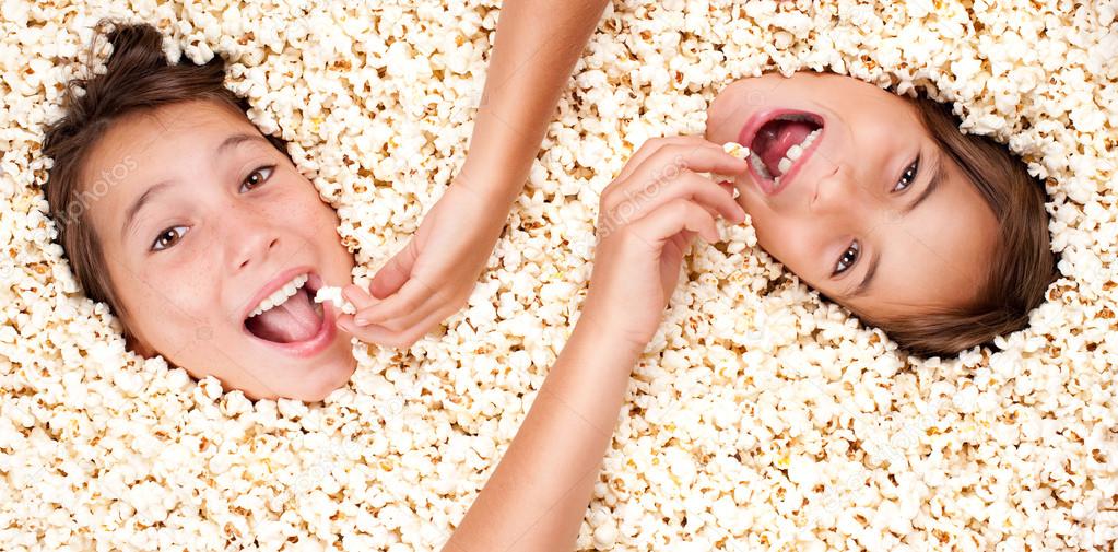 two girls buried in popcorn