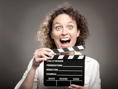 woman holding a movie clapper board