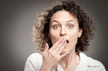 woman with hand over mouth