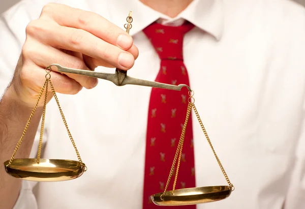 Businessman holding justice scale — Stock Photo, Image