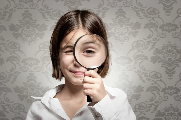 Looking at camera through magnifying glass — Stock Photo, Image