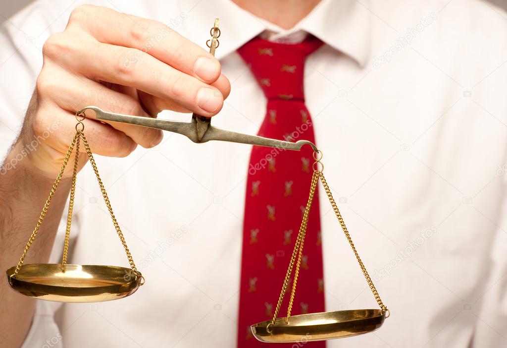 businessman holding justice scale