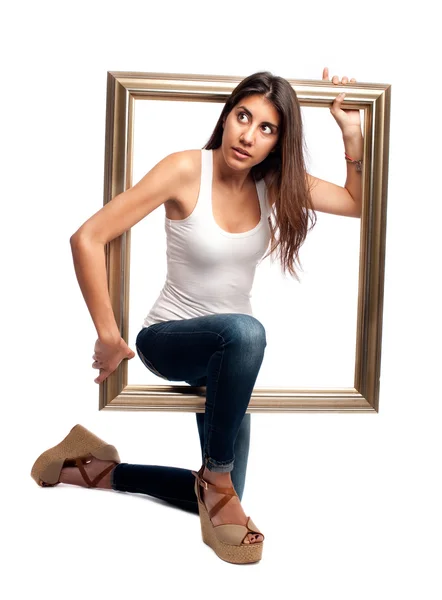 Jovem mulher segurando uma moldura — Fotografia de Stock