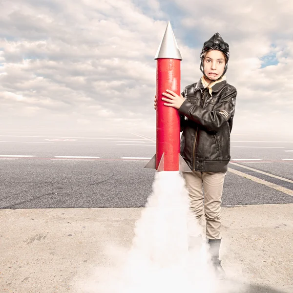 Little aviator holding a rocket — Stock Photo, Image