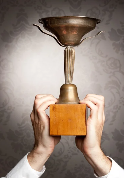 Businessman holding a trophy — Stock Photo, Image