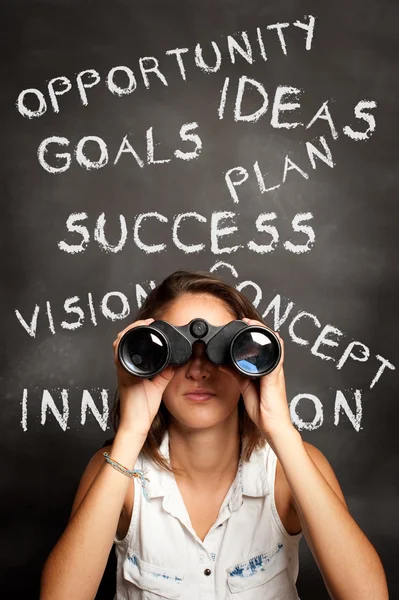 Young woman using binoculars — Stock Photo, Image