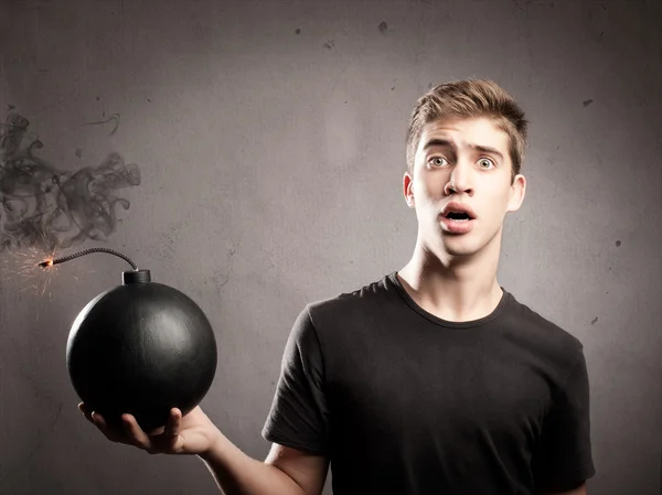 Young man holding a bomb — Stock Photo, Image