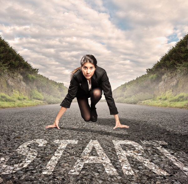 businesswoman on a road ready to run