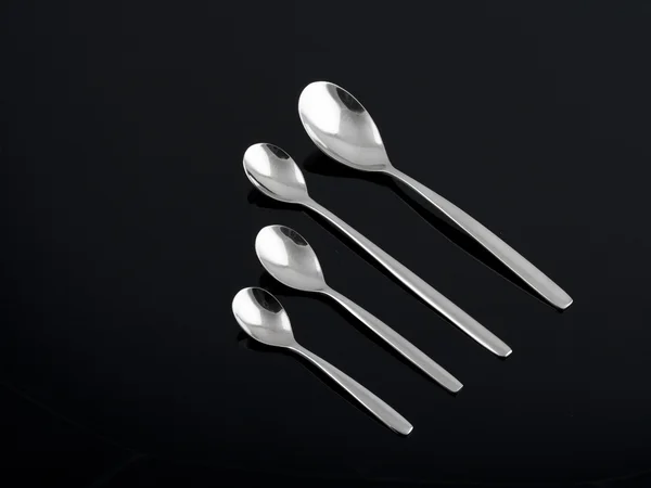 Silver spoon set on black background — Stock Photo, Image