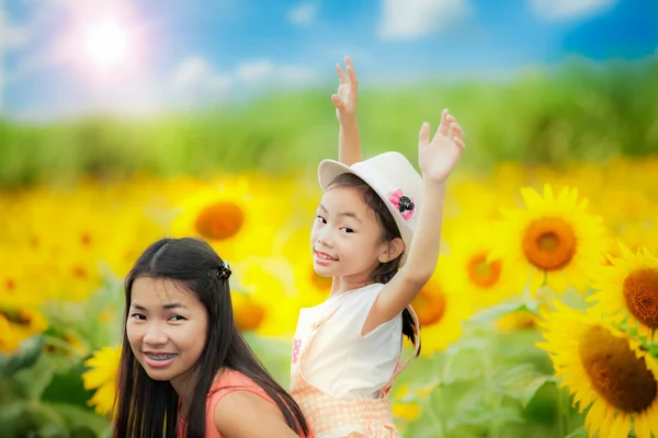 Happy family with beautiful sunflowers — Stock Photo, Image