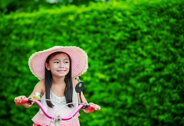 Asian little girl with her bicycle — Stock Photo, Image