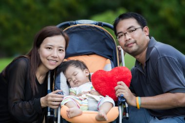 Mutlu anne, baba ve kız parkta
