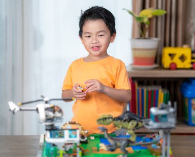 Asian boy play a block in living room at home, toy room in preschool class