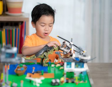 Asian boy play a block in living room at home, toy room in preschool class