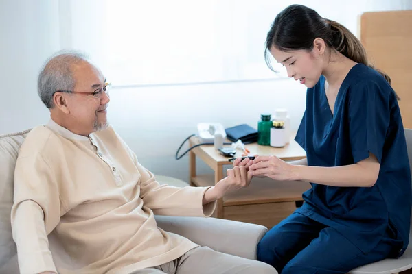 Asian nurse in nursing home examine pulse and blood sugar for old man by blood sugar check measuriment for check diabetes