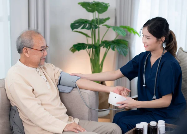 Asian nurse in nursing home examine pulse and blood pressure for old man by blood pressure checkmeasuriment