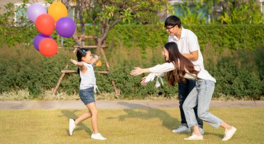 Beautiful asian family portrait smiling outside their new house with sunset, this photo canuse for family, father, mother and home concept