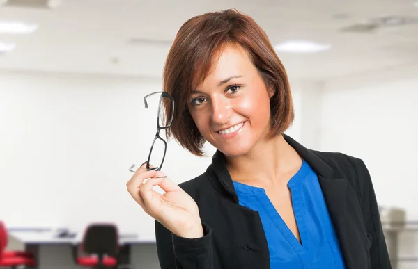 Smiling woman holding her eyeglasses — Stock Photo, Image