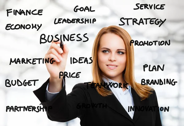 Woman writing business related words — Stock Photo, Image