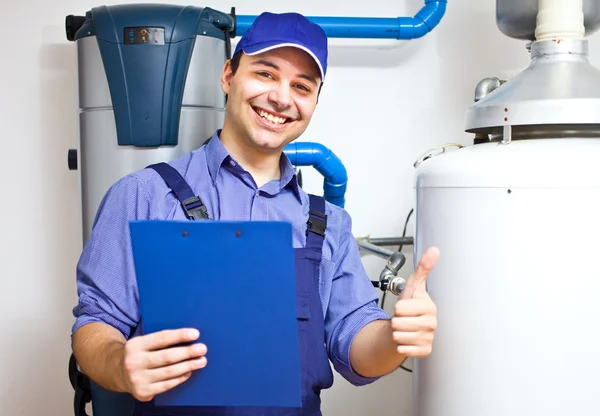 Technician servicing an hot-water heater Stock Image