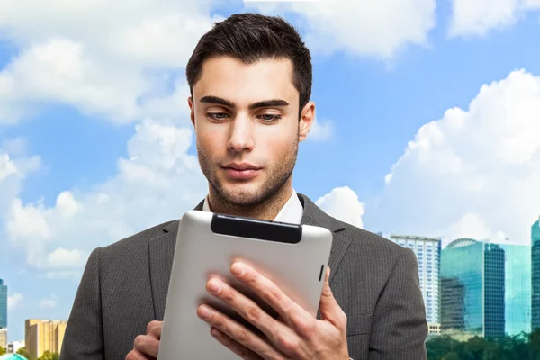 Business man holding his tablet — Stock Photo, Image