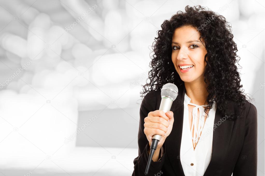 Woman speaking in a microphone
