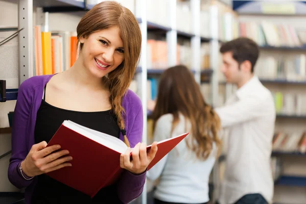 Students in a library — Stock Photo, Image