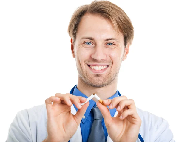 Jovem médico quebrando um cigarro — Fotografia de Stock