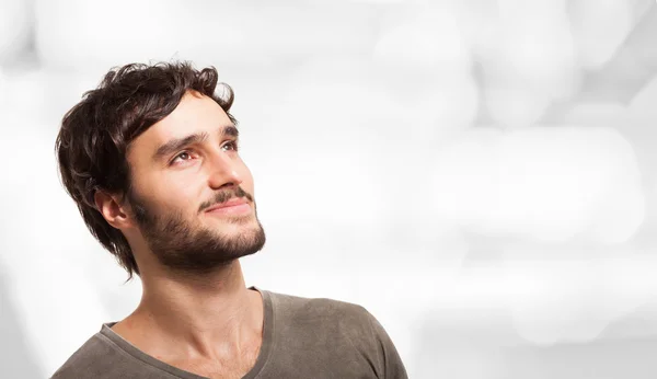 Smiling young man looking up — Stock Photo, Image
