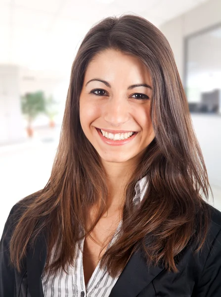 Attractive businesswoman standing in her office — Zdjęcie stockowe