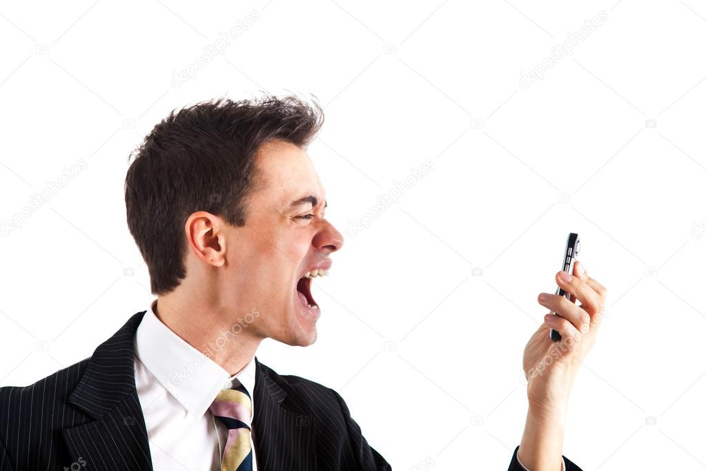 Businessman screaming at the phone.