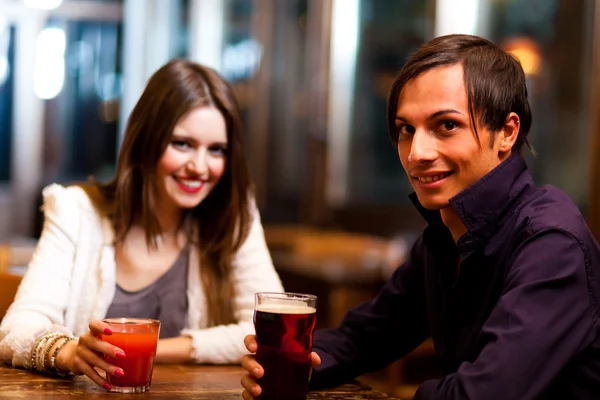 Friends having a drink in a pub — Stock Photo, Image
