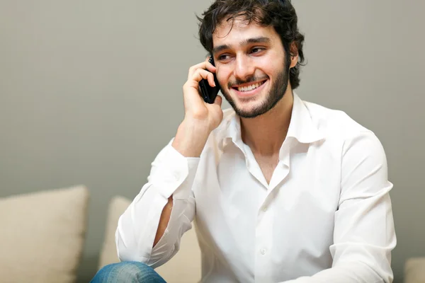 Portrait of a young man using a mobile phone — Stock Photo, Image