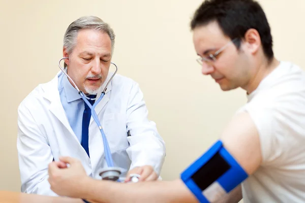 Läkare kontrollerar blodtrycket — Stockfoto