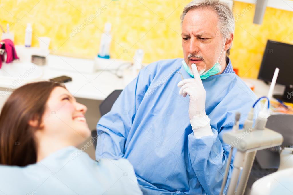 Dentist talking to a patient — Stock Photo © minervastock 30021917