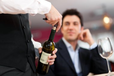 Waiter serving wine clipart