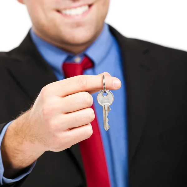 Young businessman holding a key — Stock Photo, Image