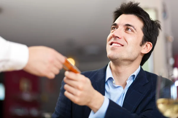 Closeup portrait of businessman paying with credit card — Stock Photo, Image