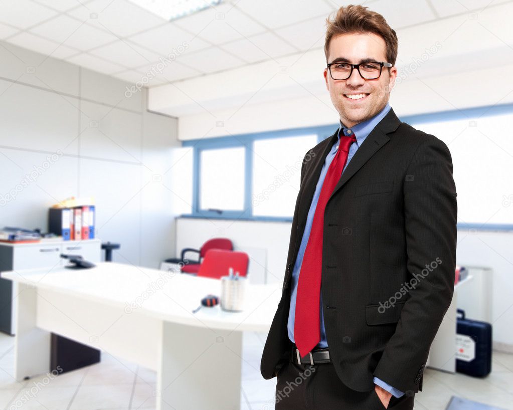Confident young businessman in his office