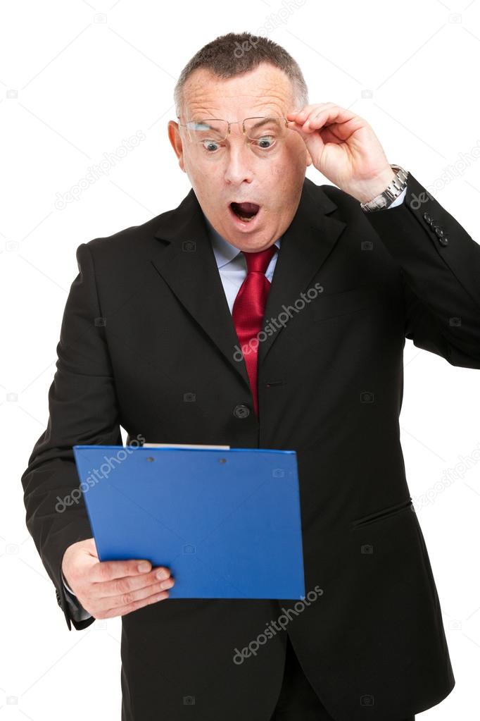 Shocked businessman isolated on white while reading an expensive bill