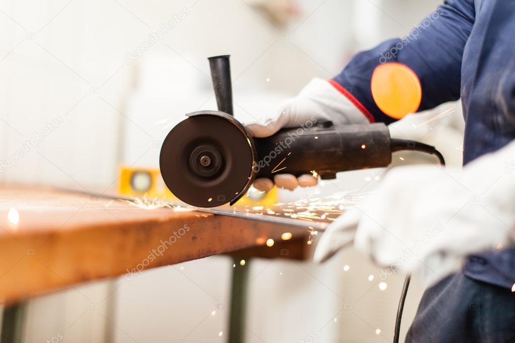 Worker using a grinder