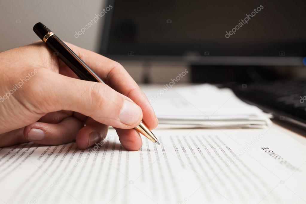 Man checking text on a document