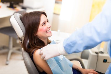 Dentist preparing a patient clipart