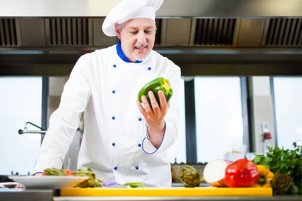 Chef cooking in his kitchen — Stock Photo, Image