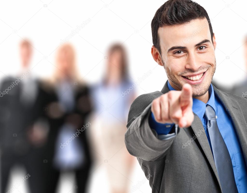 Smiling businessman pointing his finger