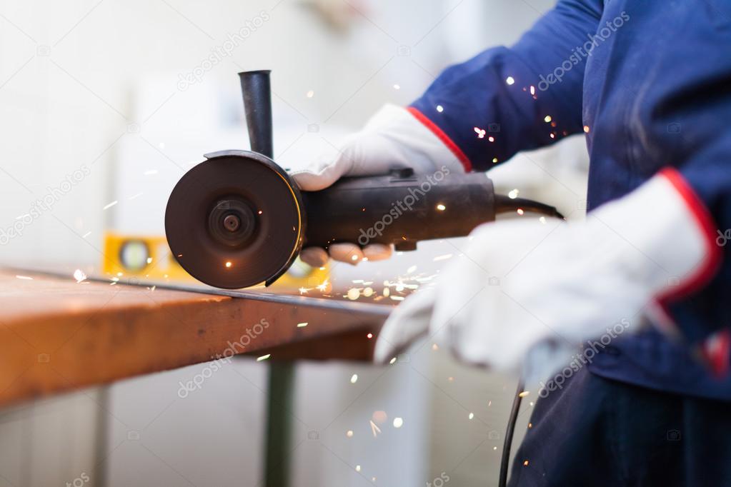 Worker cutting a metal plate