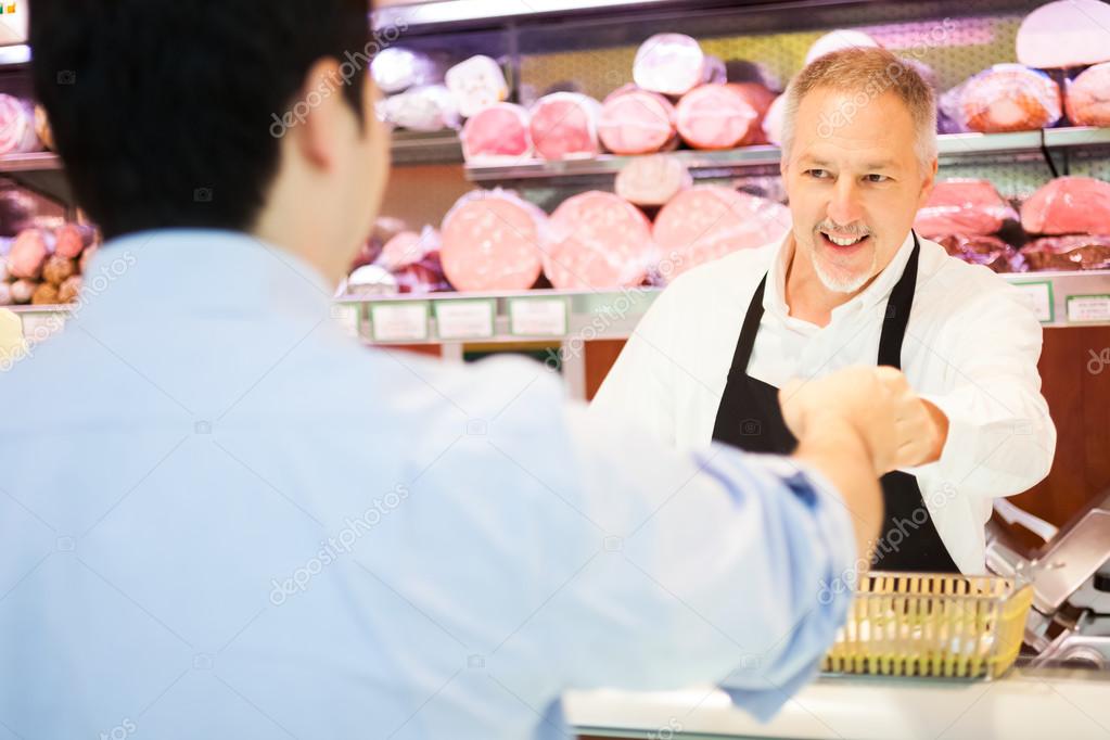 Shopkeeper serving a customer